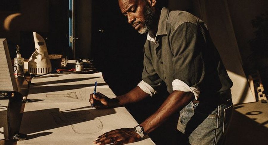 A person working at a desk in low light, mid-morning