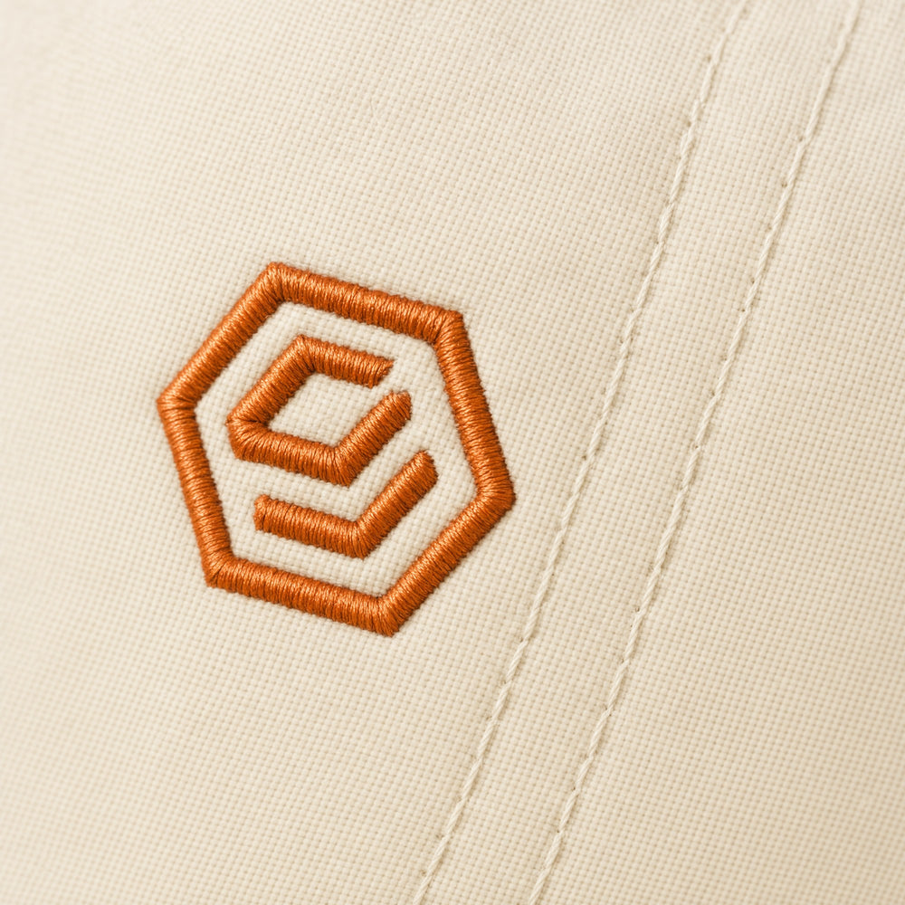 The embroidered hex mark on the Solve Cap, Bone