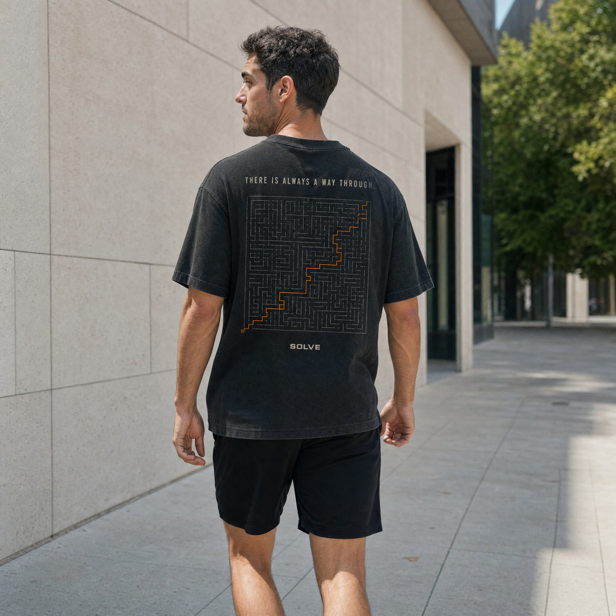A man walking away in the A Way Through Tee, the maze on his back