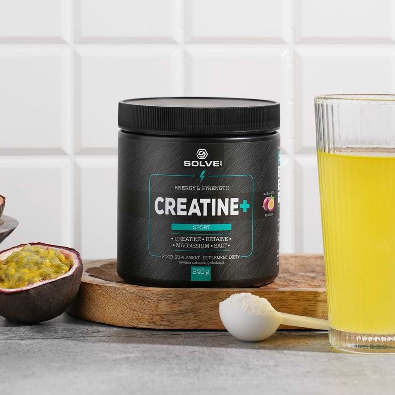 Creatine+ tub with a scoop and fresh passion fruit