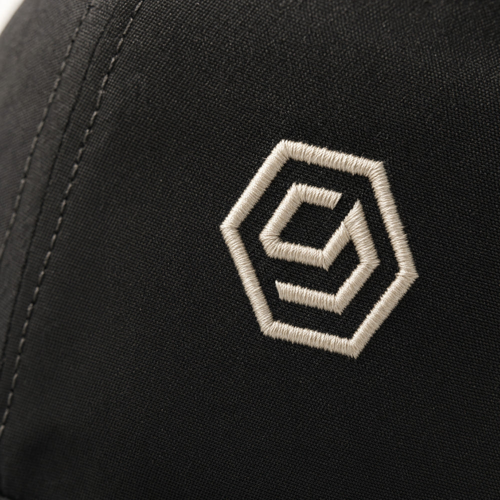 The embroidered hex mark on the Solve Cap, Ink