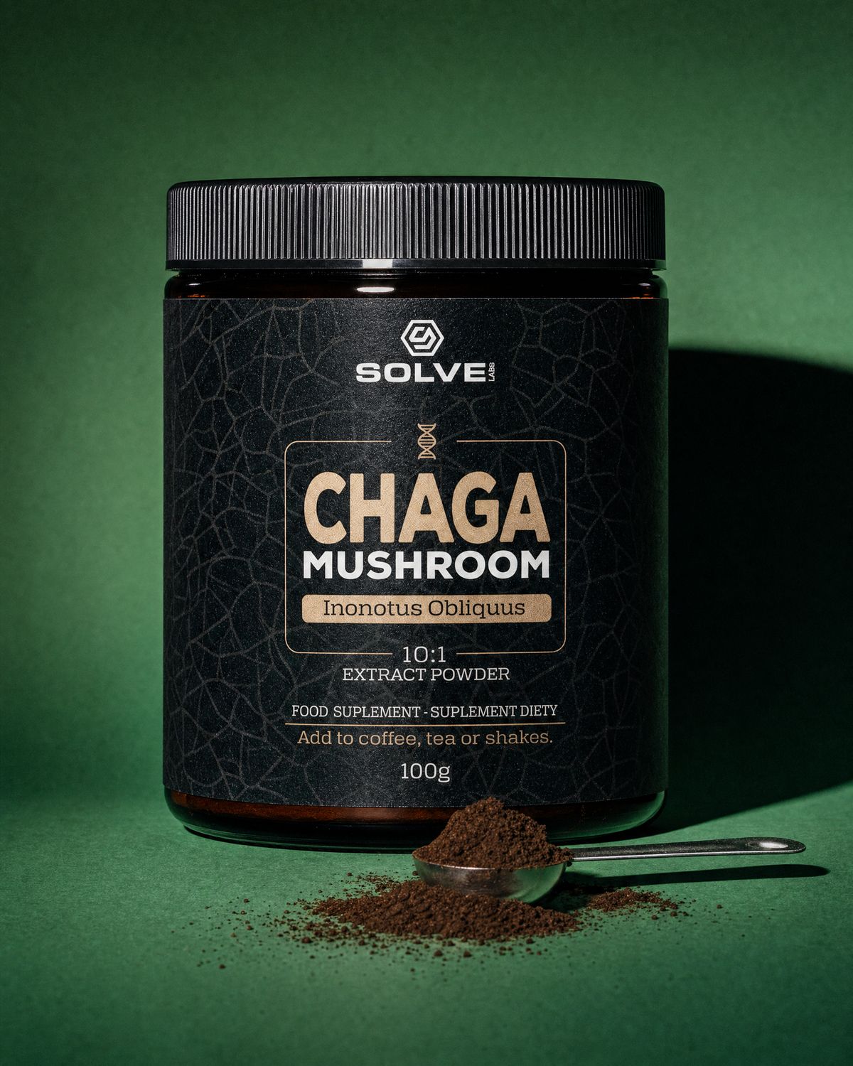 A jar of Solve Labs Chaga powder on a forest-green backdrop with a spoon of the powder