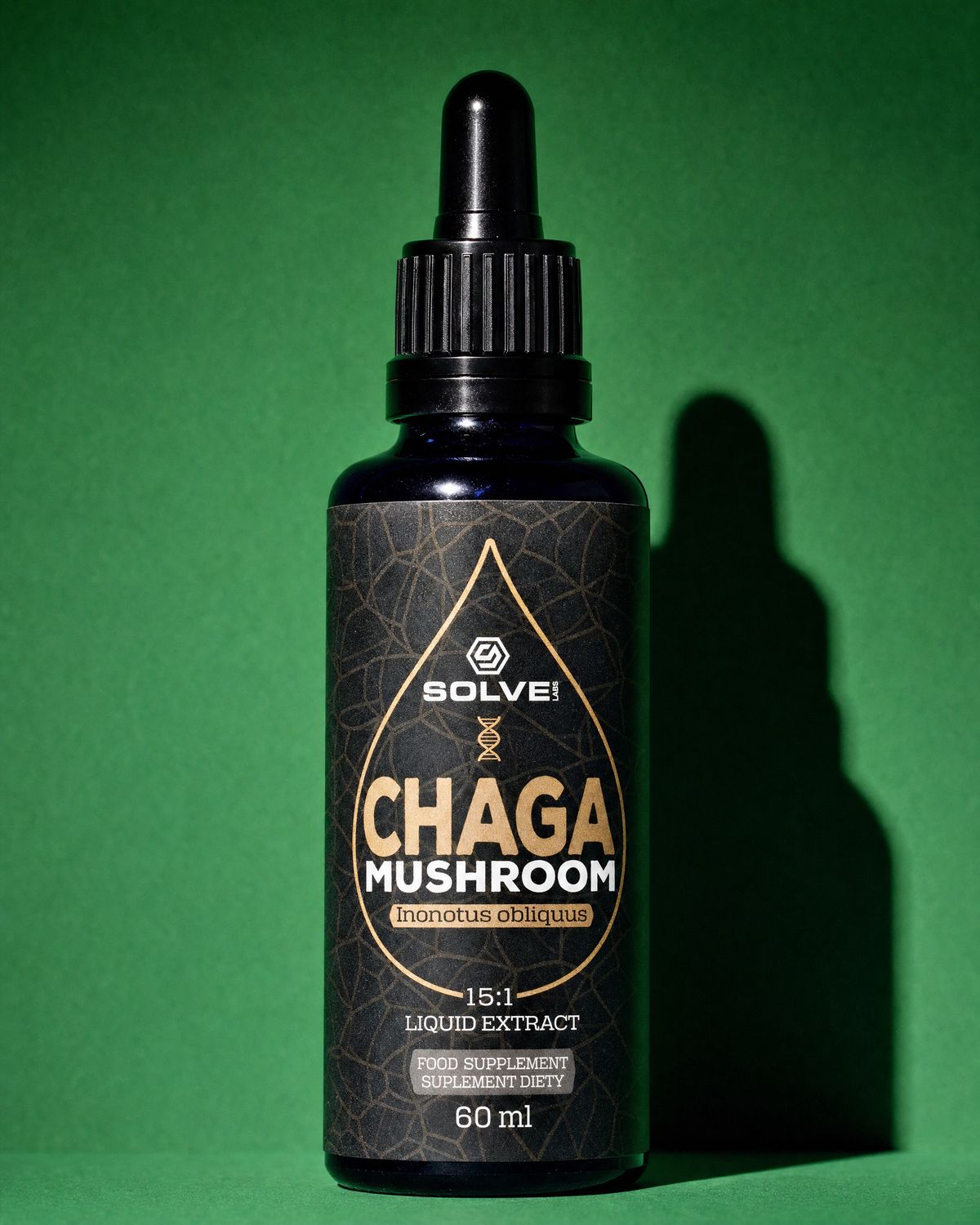 A bottle of Solve Labs Chaga drops on a forest-green backdrop