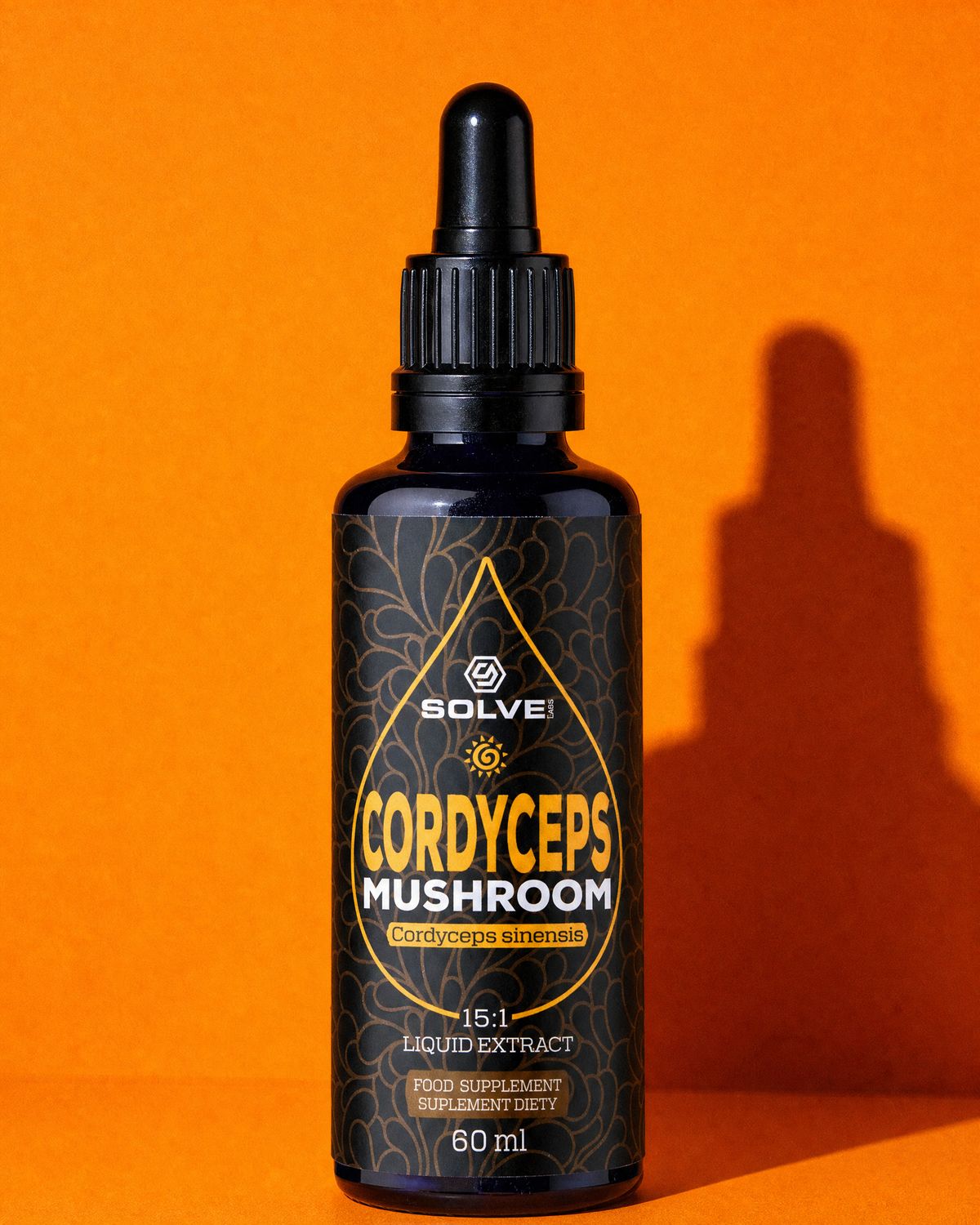 A bottle of Solve Labs Cordyceps drops on an orange backdrop