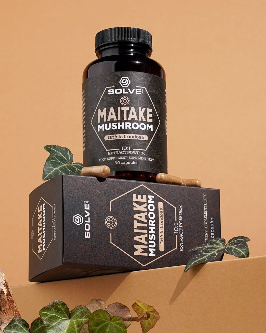 El bote de Solve Labs Maitake en cápsulas sobre su caja, con hiedra
