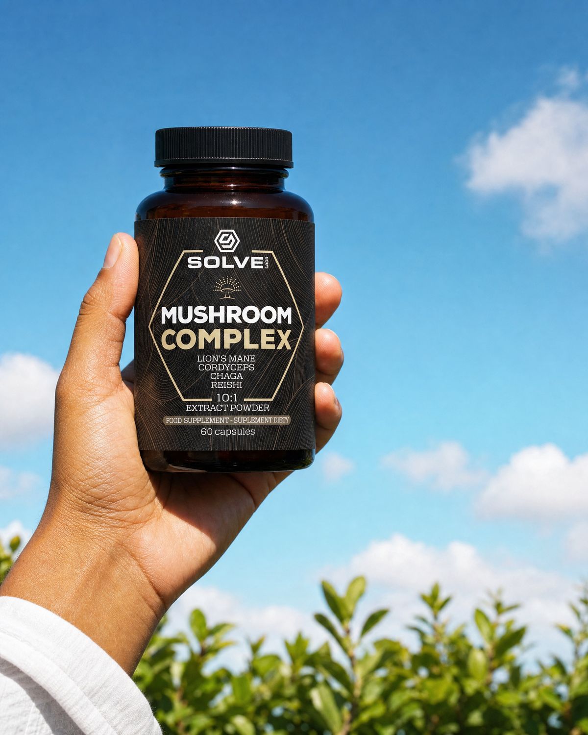 A hand holding up a jar of Solve Labs Mushroom Complex capsules against a blue summer sky