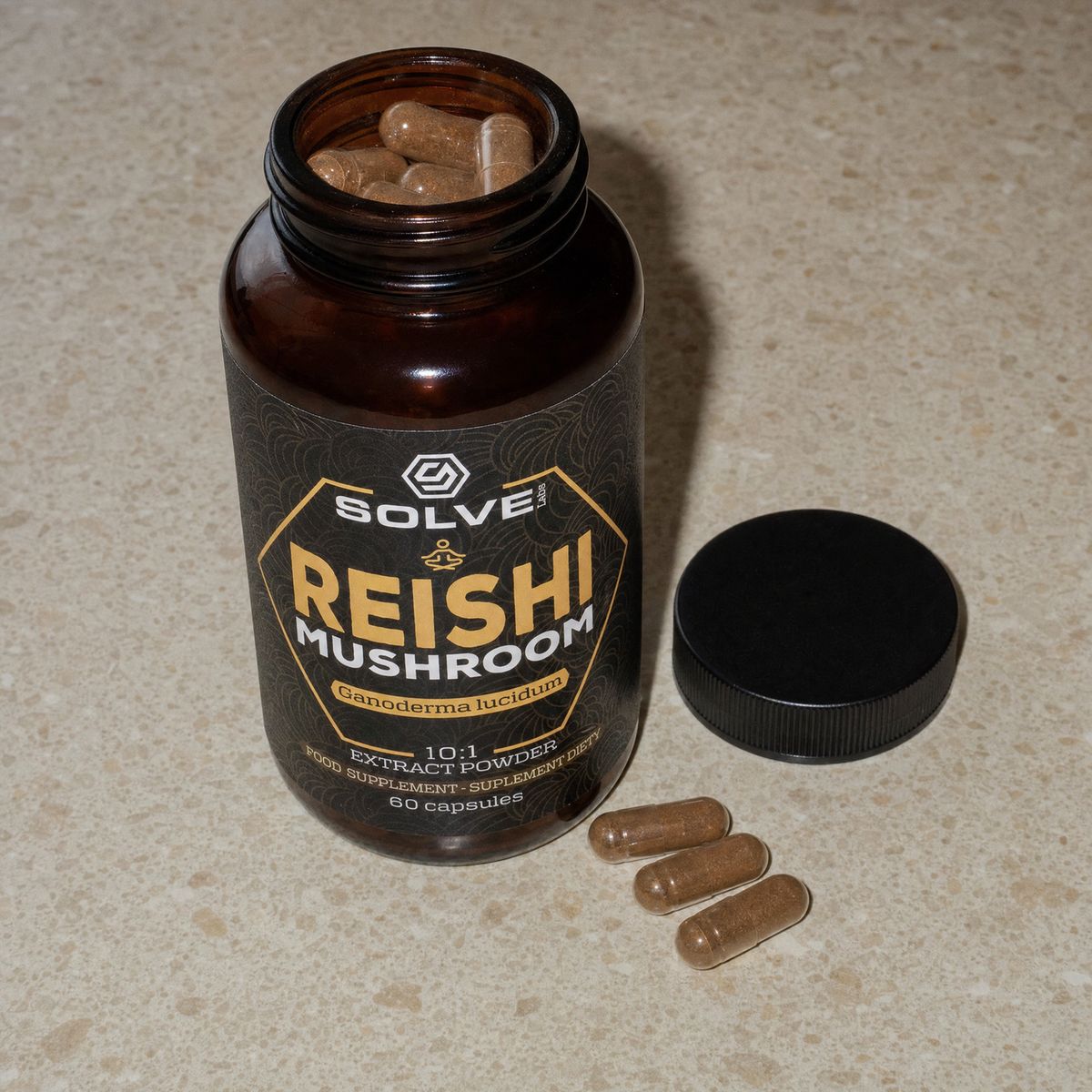 The open jar of Solve Labs Reishi capsules, three capsules beside its cap