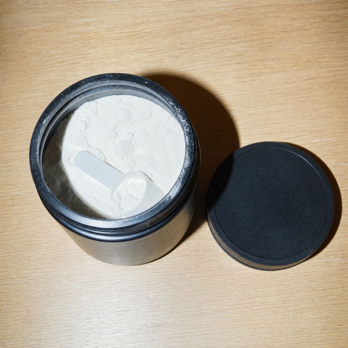 Looking into the open tub: white powder and a white scoop