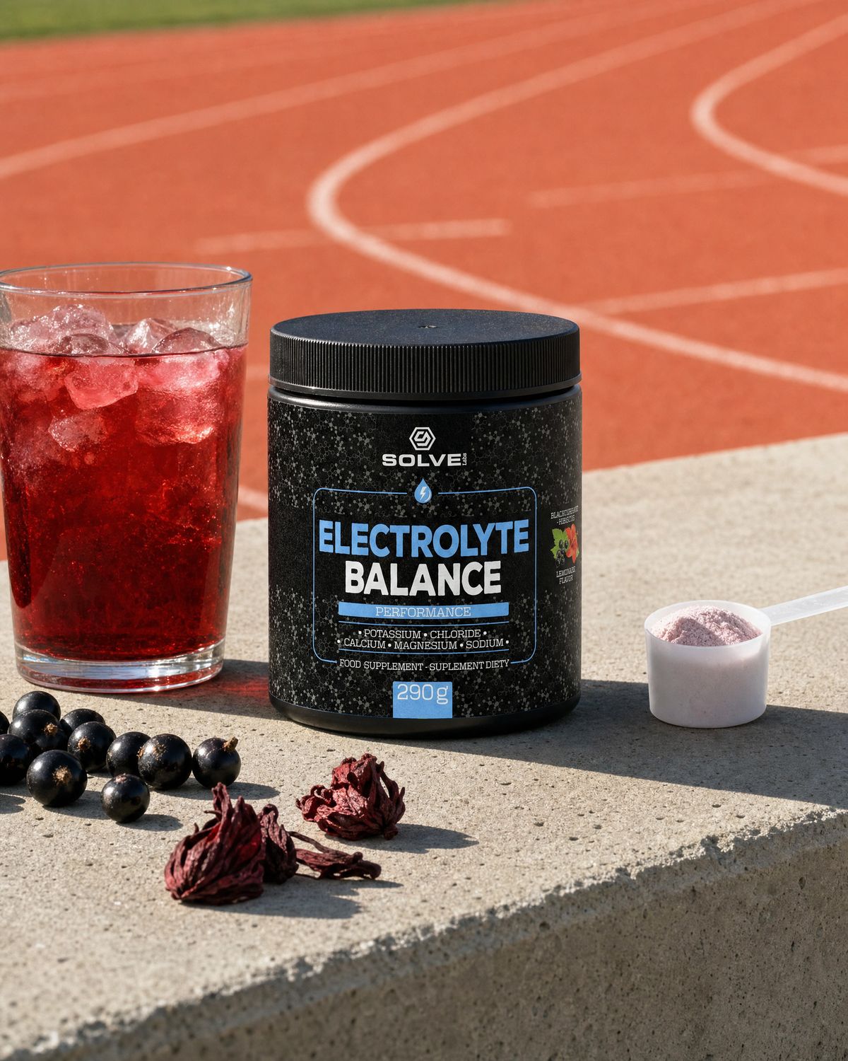 The tub of Solve Labs Electrolyte Balance on a concrete bench with a glass of the red drink, a scoop of pink powder, blackcurrants and dried hibiscus
