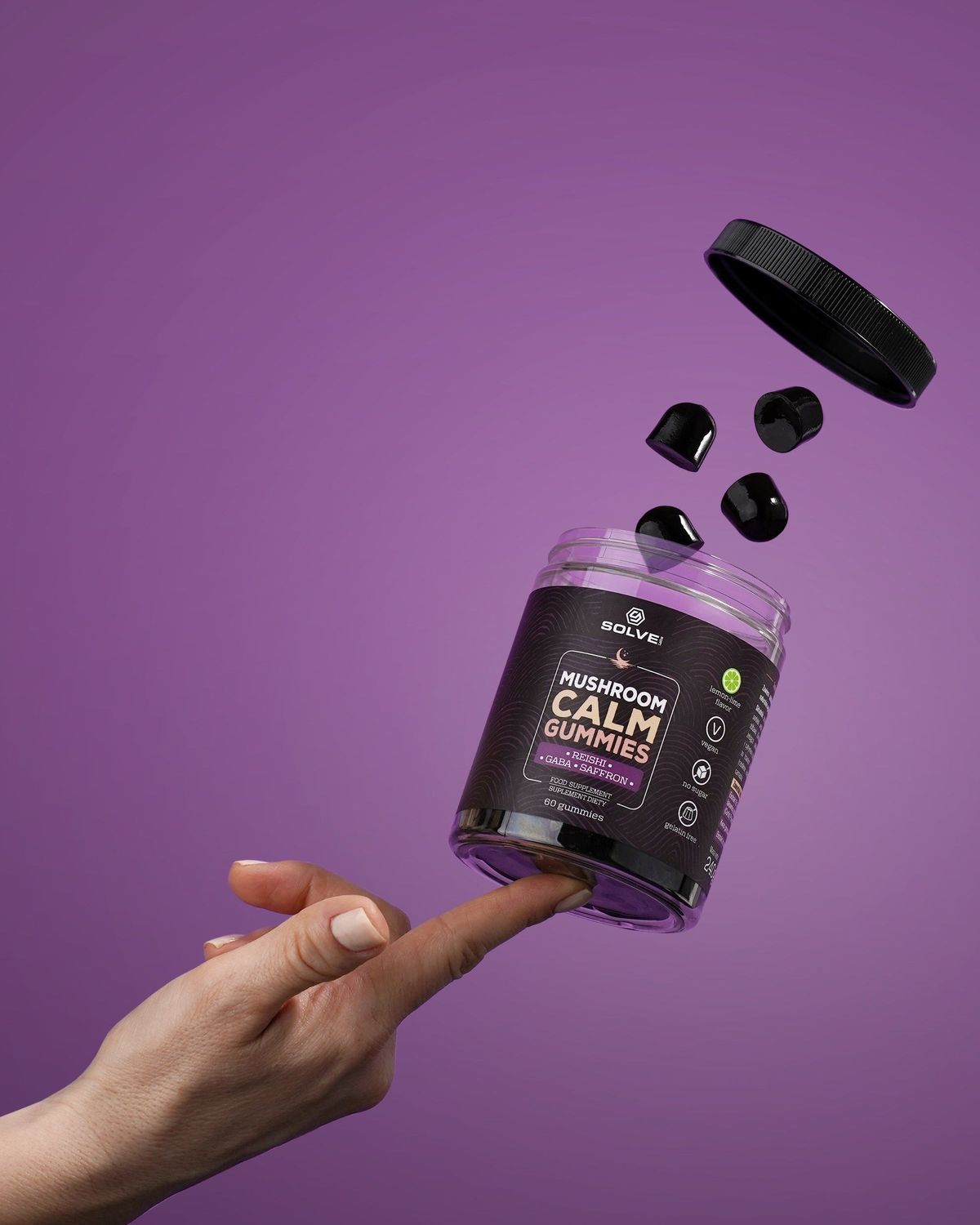 The jar of Solve Labs Mushroom Calm Gummies floating among gummies above an open hand on a purple backdrop