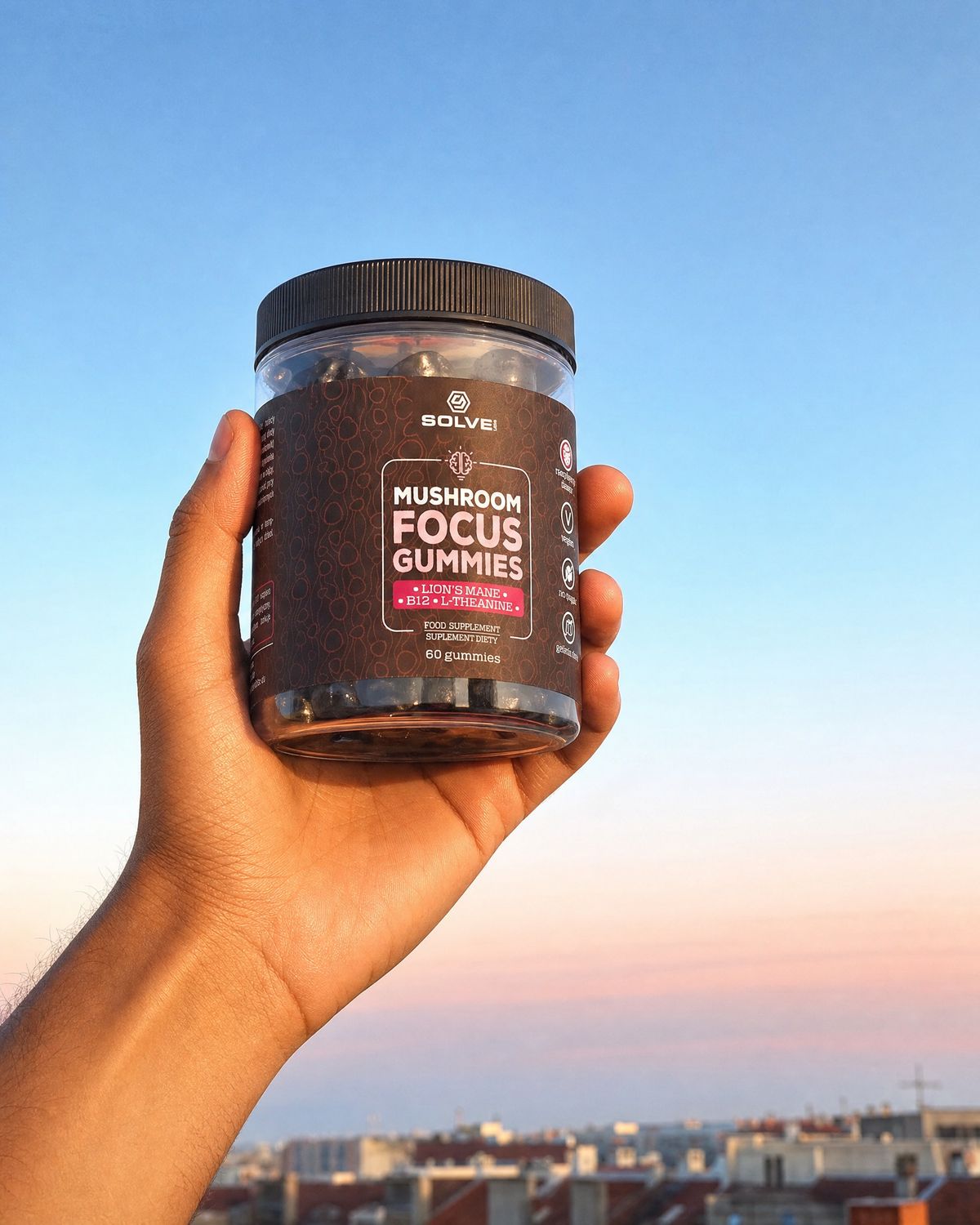 A hand holding up the jar of Solve Labs Mushroom Focus Gummies against a pink morning sky