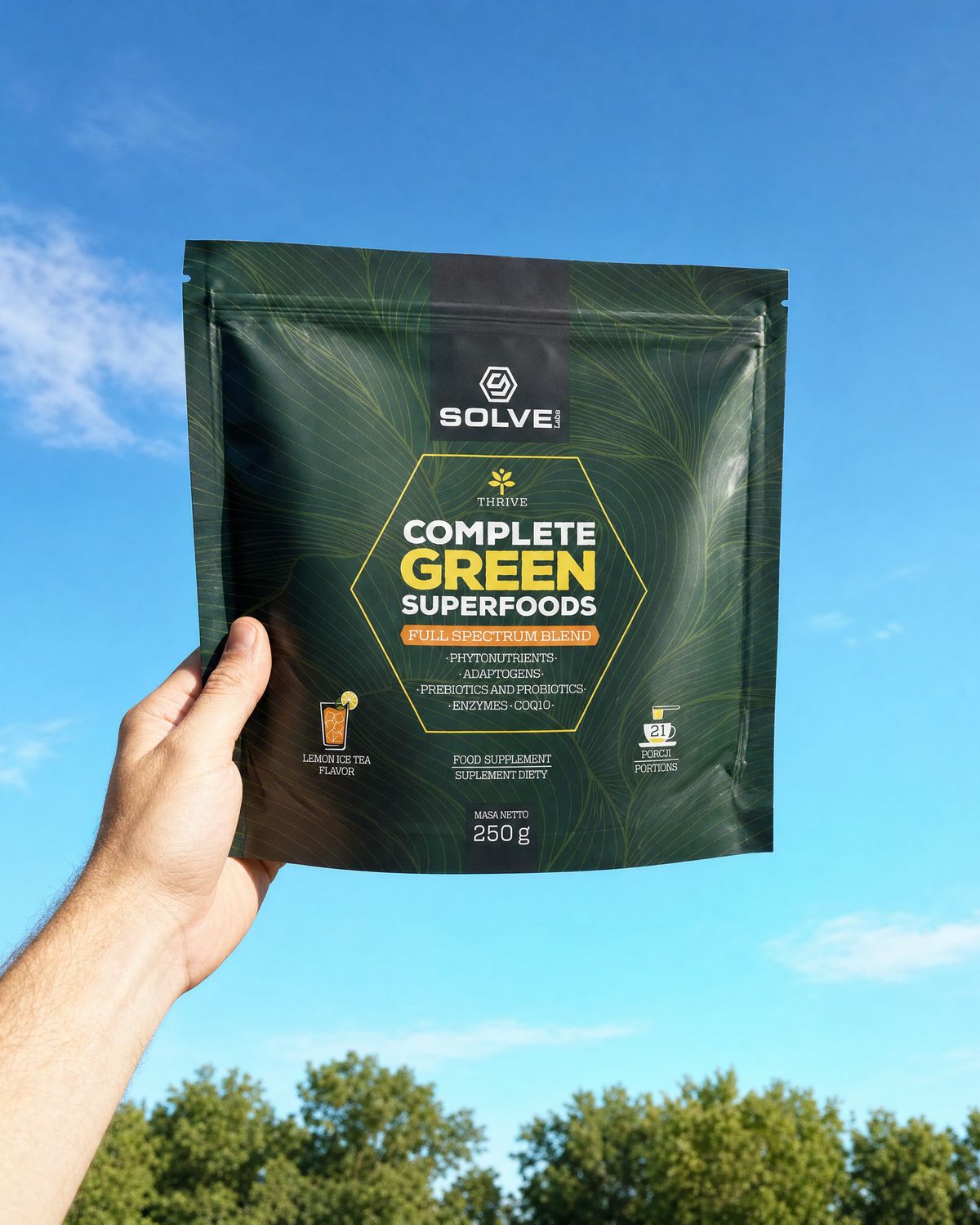 A hand holding up the pouch of Solve Labs Complete Green Superfoods against a morning sky