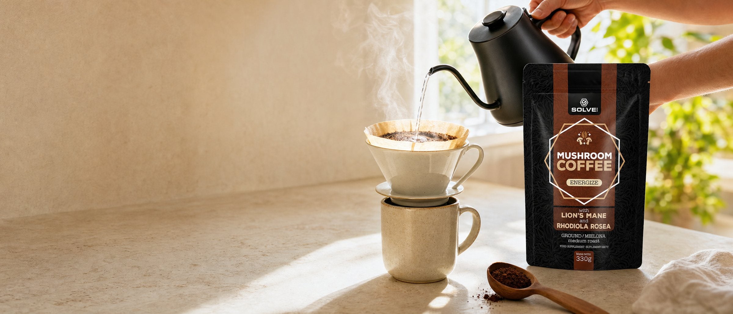 Hot water poured from a black kettle over ground coffee in a dripper on a stoneware mug, steam in the window light, the pouch of Solve Labs Mushroom Coffee beside it
