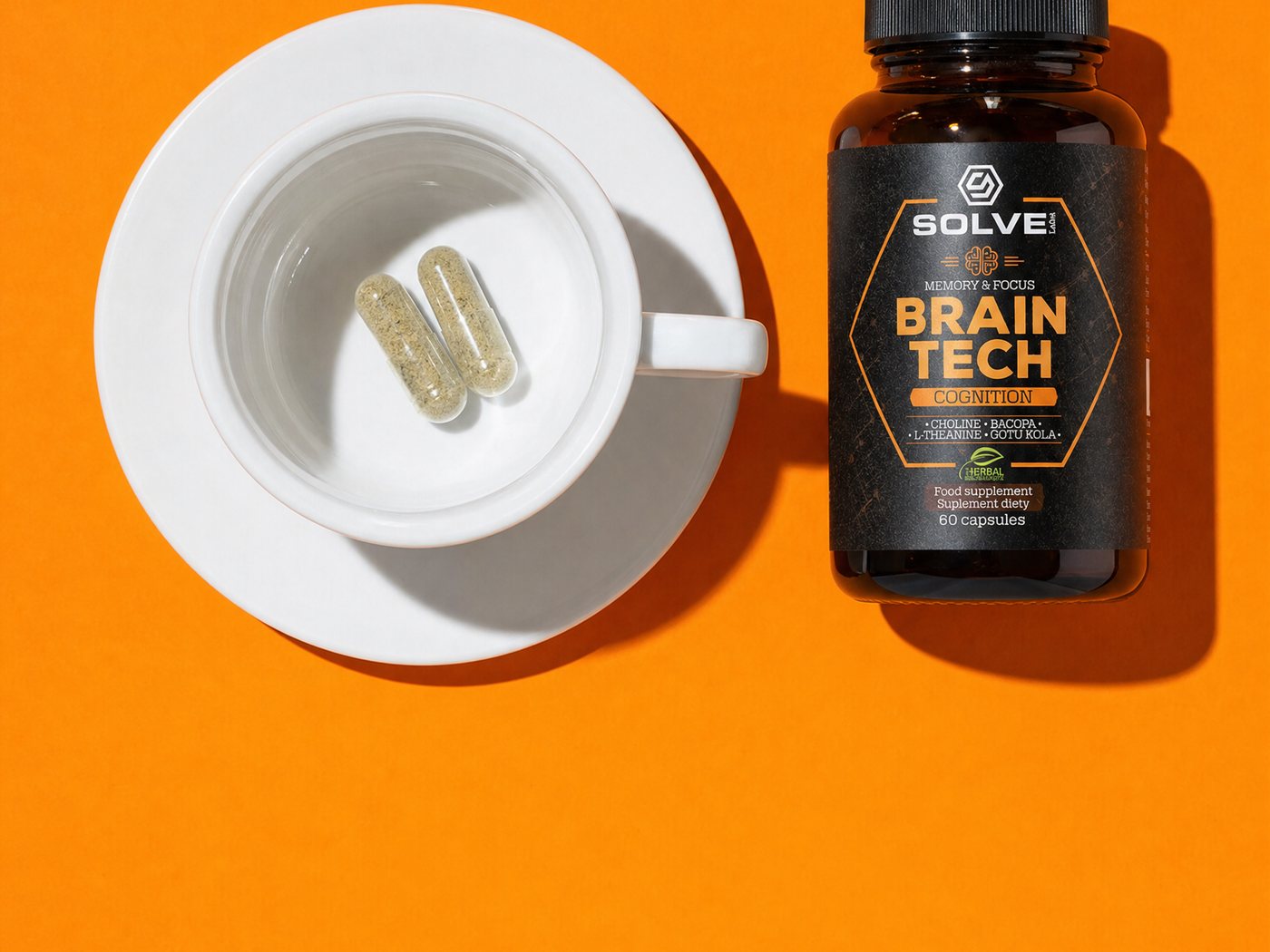 An empty white espresso cup seen from above with two capsules in it, the Brain Tech jar beside it, on an orange ground