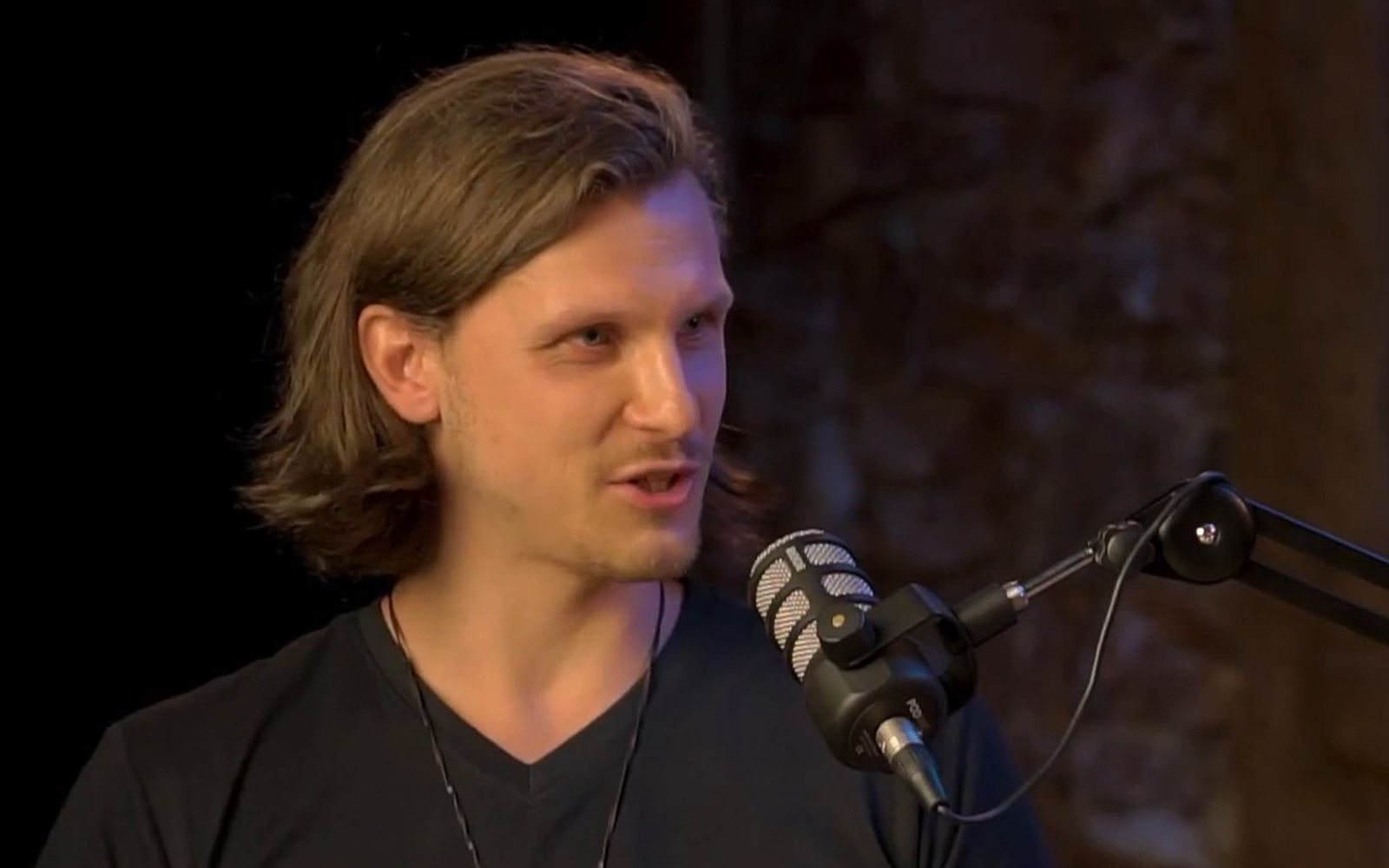 Jacob, the founder of Solve Labs, speaking into a studio microphone
