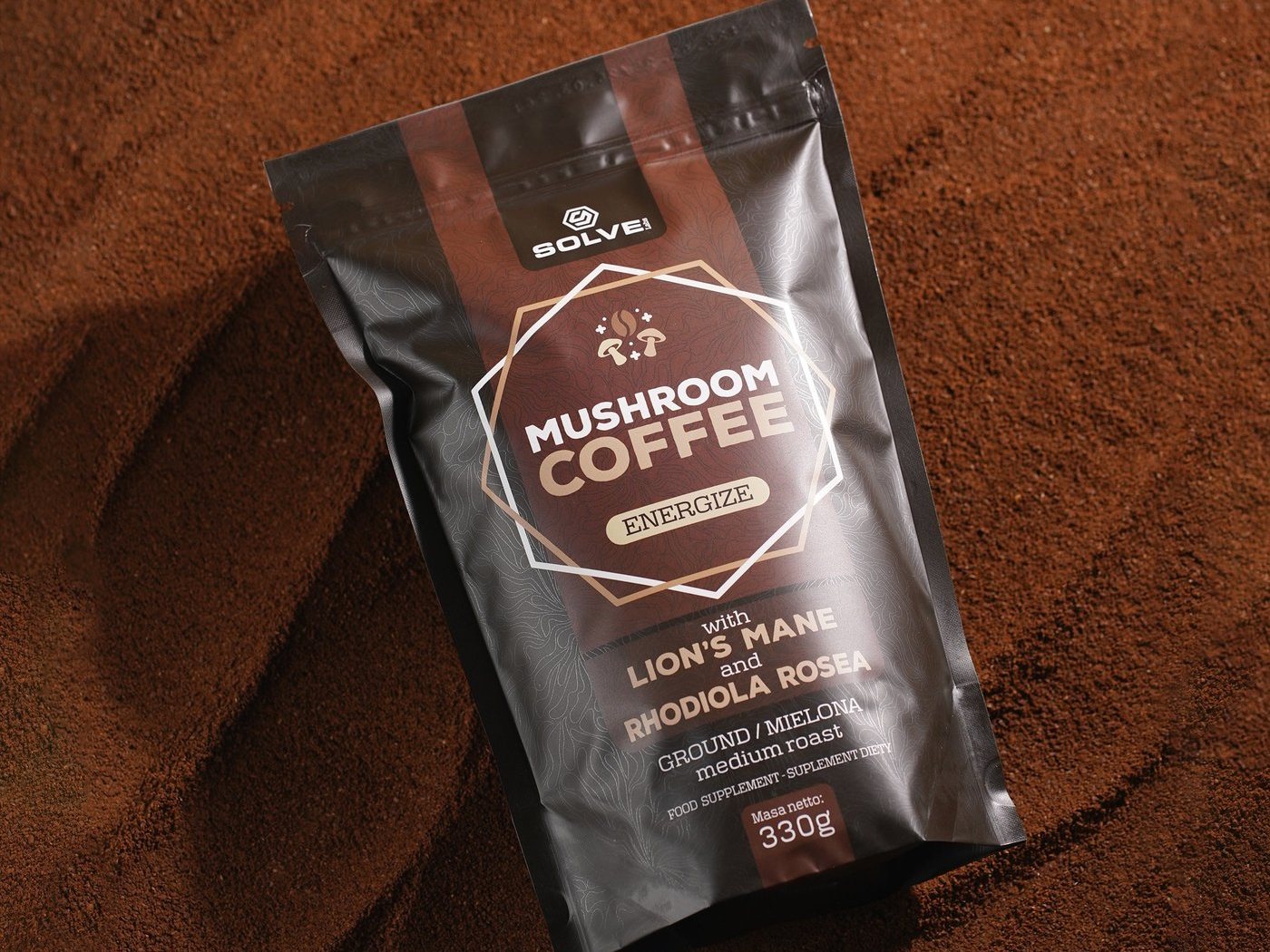 The Mushroom Coffee bag lying on a bed of ground coffee