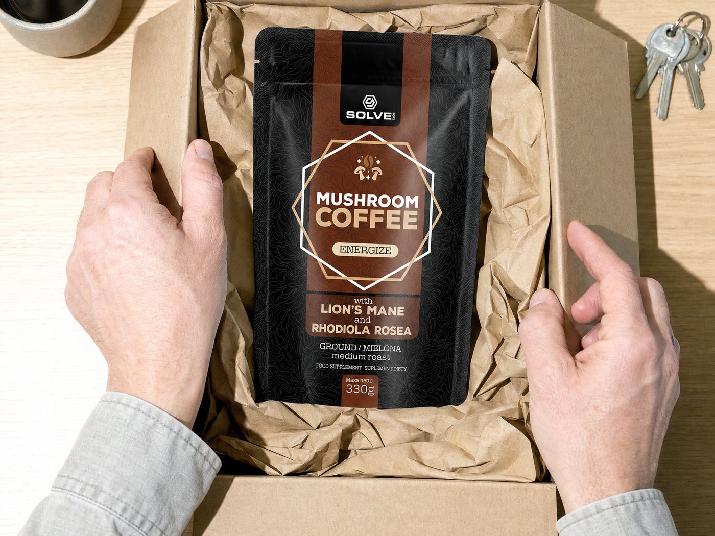 Hands opening a delivery box with the Mushroom Coffee bag inside