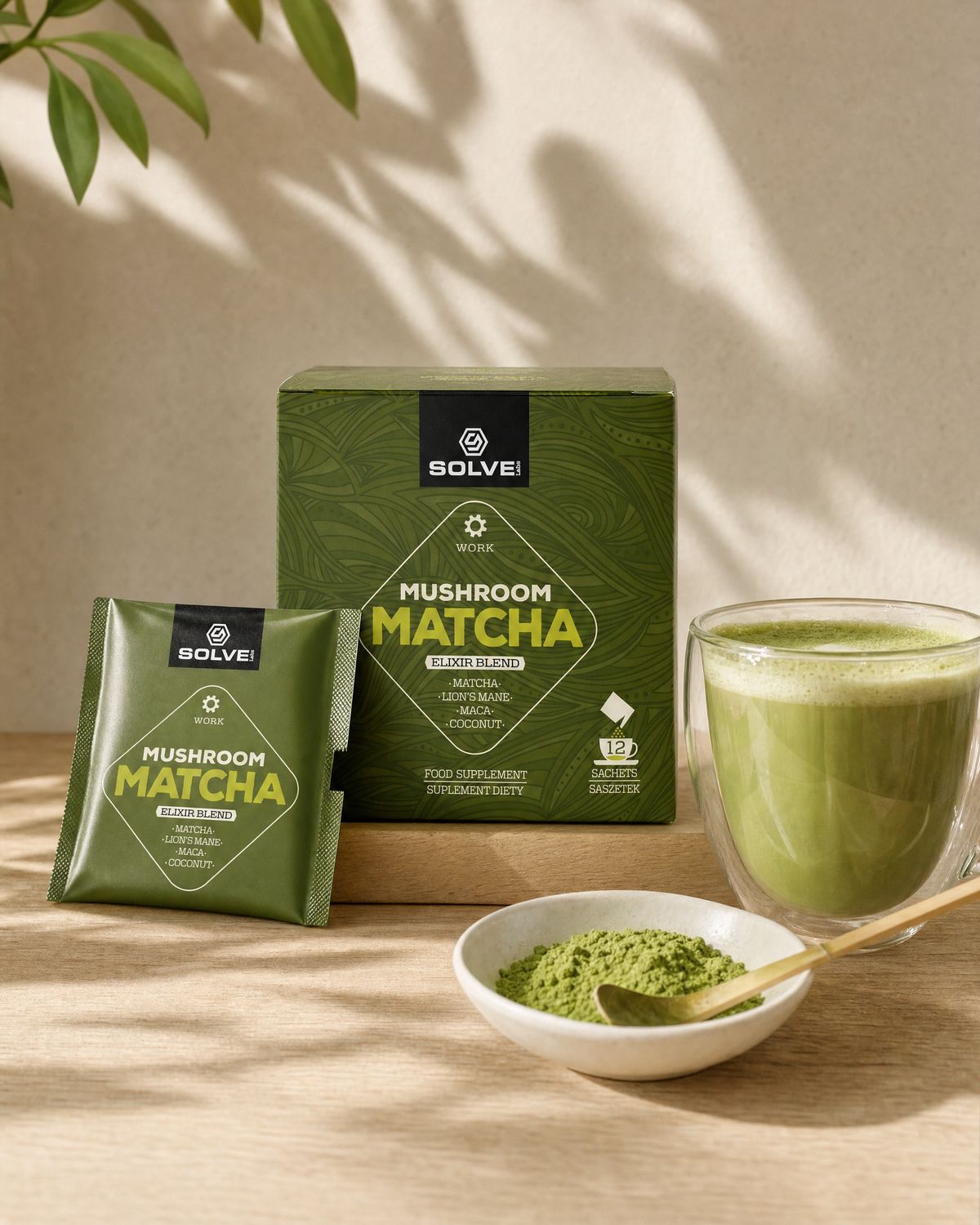 The box of Solve Labs Mushroom Matcha on a counter with a sachet, a matcha latte in a glass cup and a bowl of matcha powder