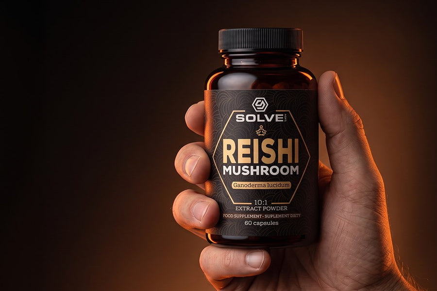 A hand holding a jar of Solve Labs Reishi capsules in warm light